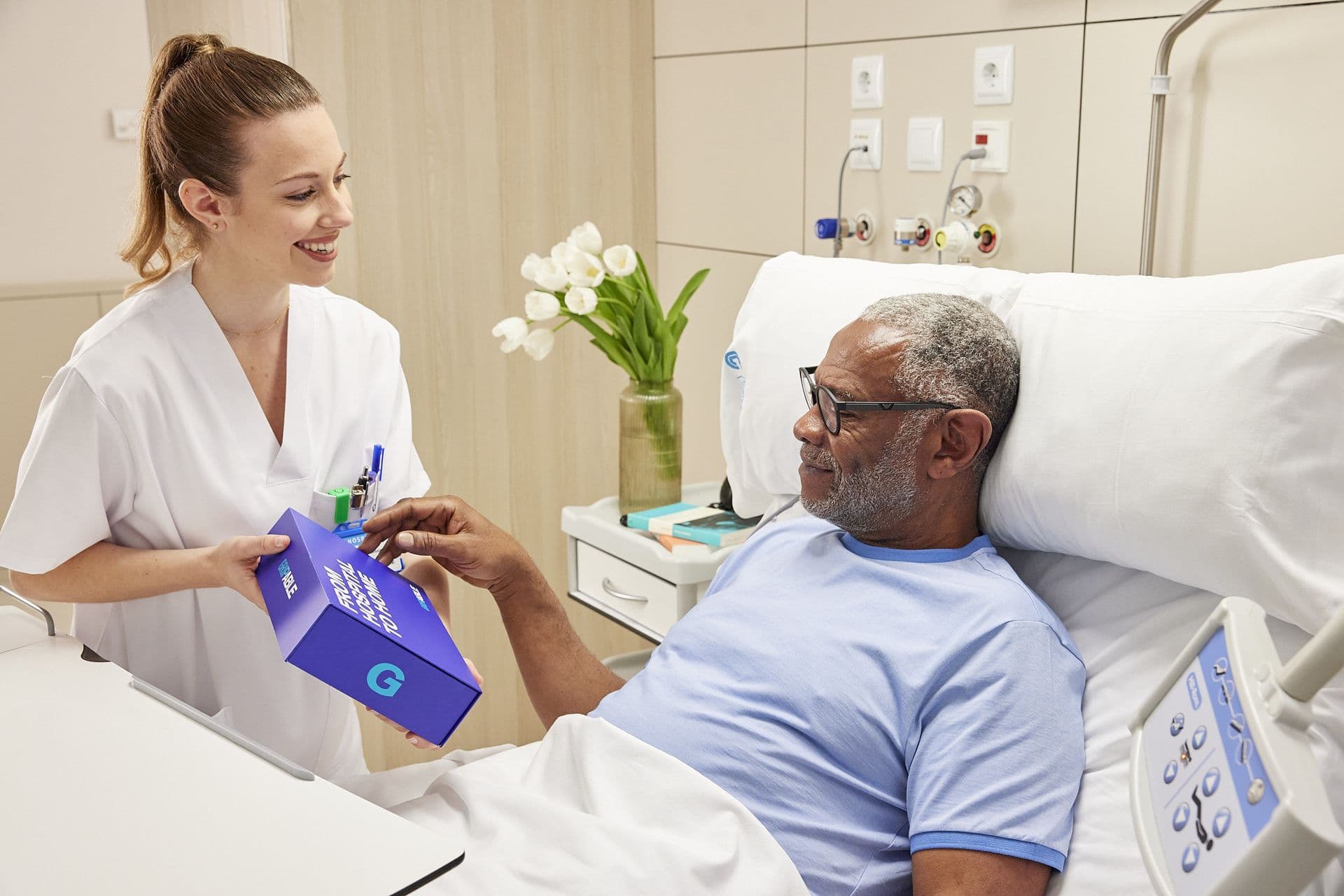 Nurse handing the Able Assess kit to a colleague